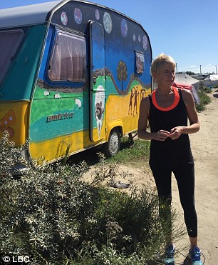 She stands outside Allam's brightly coloured caravan in the Jungle