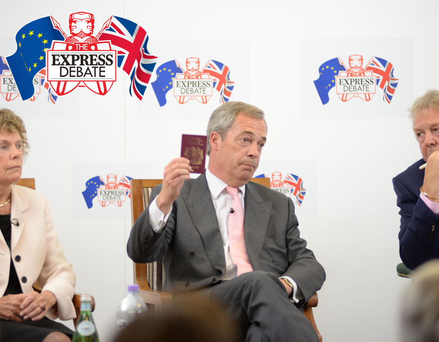 Nigel Farage holds up his British passport during the debate