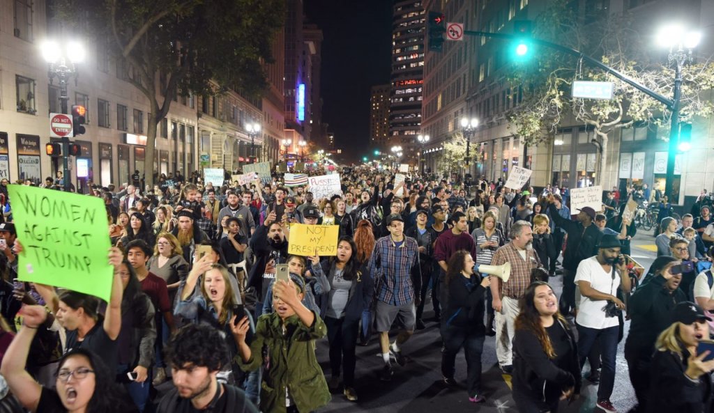 People march and shout during an anti-Trump protest in Oakland, California on November 9, 2016. Thousands of protesters rallied across the United States expressing shock and anger over Donald Trump's election, vowing to oppose divisive views they say helped the Republican billionaire win the presidency. / AFP / Josh Edelson (Photo credit should read JOSH EDELSON/AFP/Getty Images)