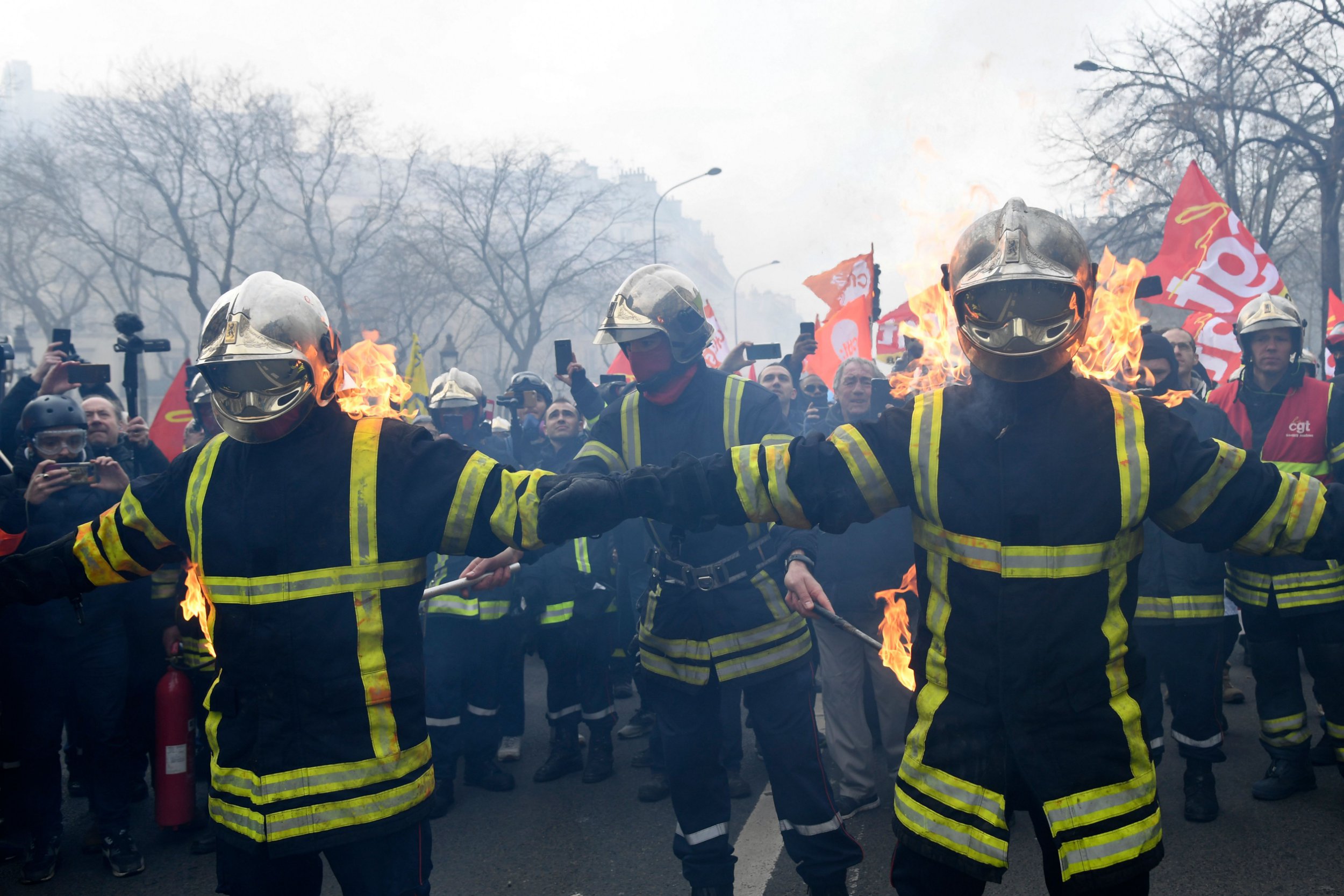 Firefighters set themselves alight as they take part in a demonstration to protest against French government's plan to overhaul the country's retirement system in Paris, on January 28, 2020. (Photo by Bertrand GUAY / AFP) (Photo by BERTRAND GUAY/AFP via Getty Images)